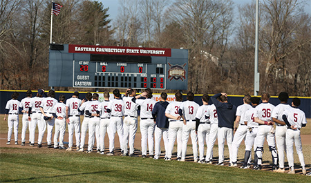 Baseball players facing away from the camera