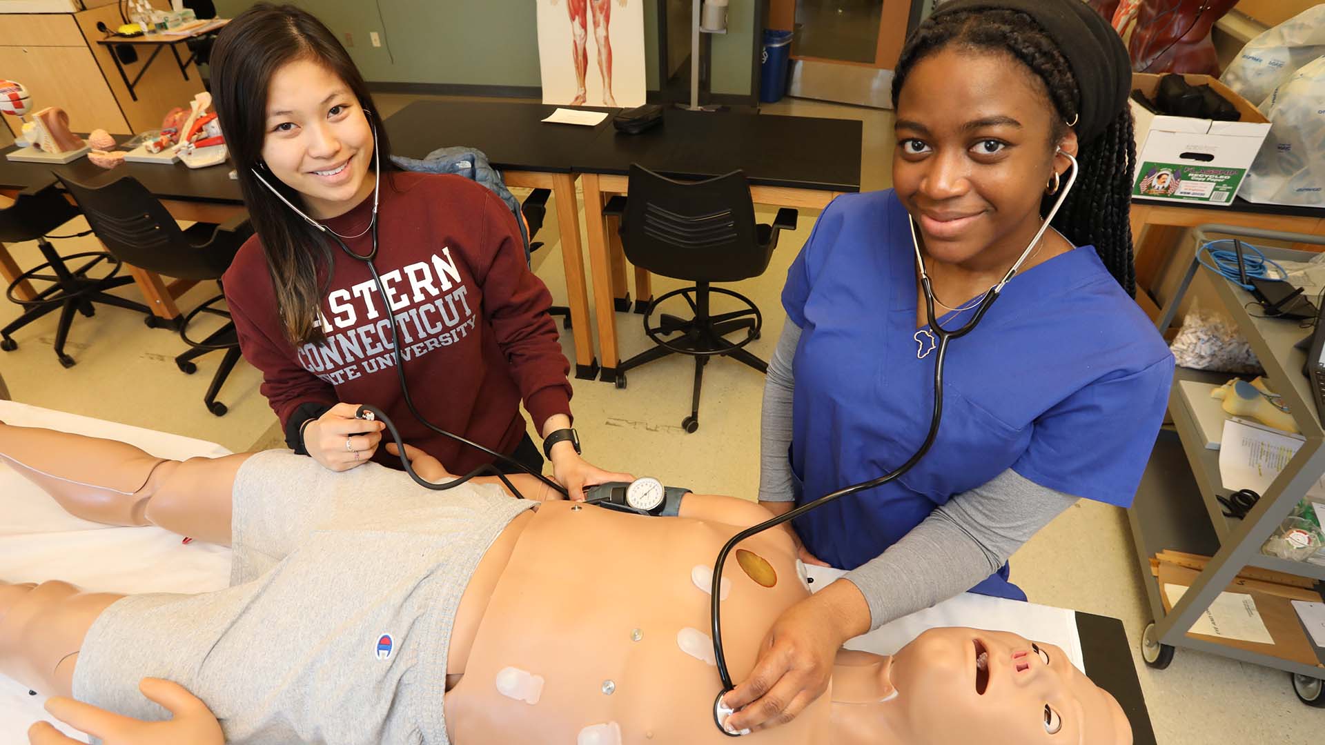 nursing students using a training dummy
