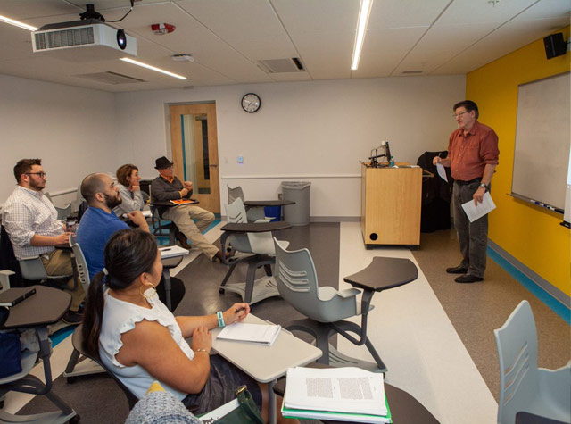 Professor lecturing to graduate division class