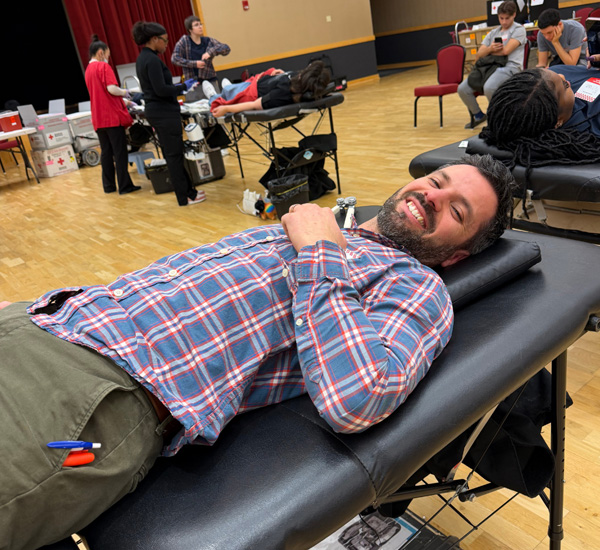Staff member of Eastern donating blood