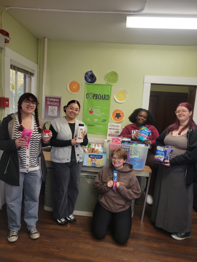 Women's center ambassadors dropping off HERFest hygiene donations.
