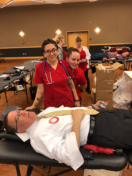 Man giving blood at an annual blood drive