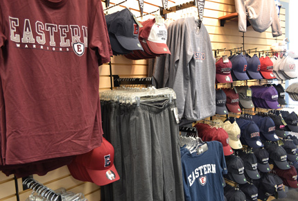 t-shirts, hats and other merchandise hanging on the wall in the Eastern Bookstore