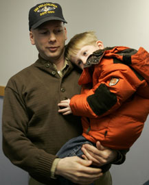 Man in uniform holding child