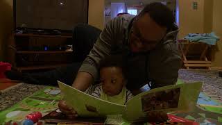  Father and infant look at book 