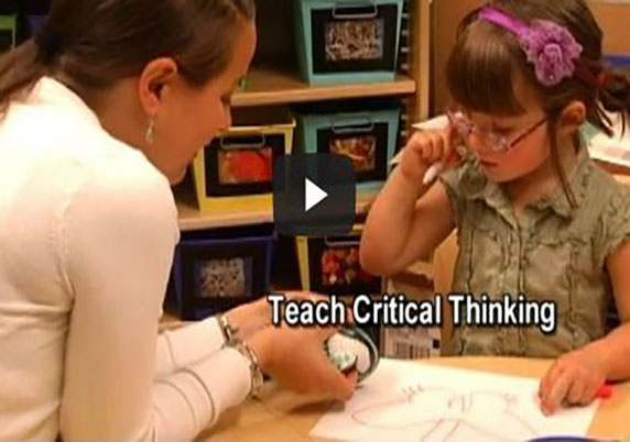 A teacher and child work on a sketch together in the art center.