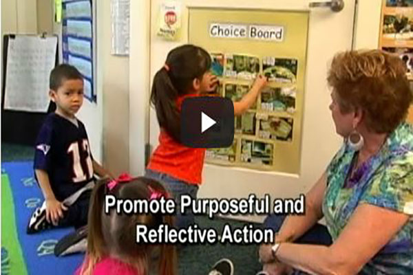 Children sit in a group and use a picture schedule to reflect on their day.