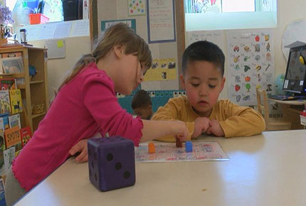 Two children playing a board game. 