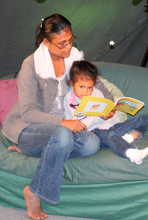 A mother reads to her toddler