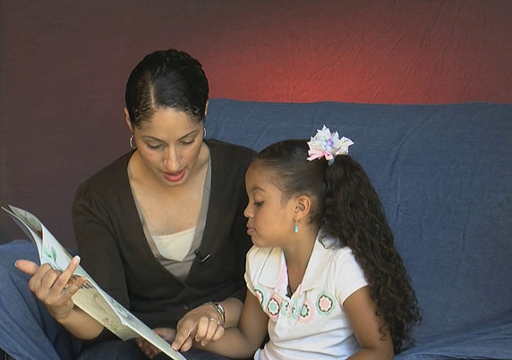 Mother reads to her daughter.