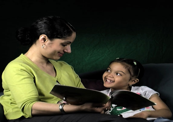 Mother reading to her daughter.