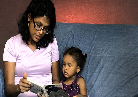 A mother and child read together.