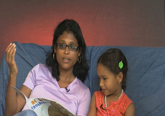 A brother and sister read together.