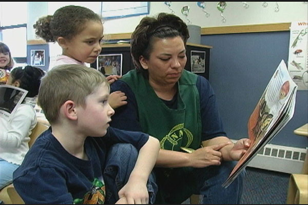 A teacher reads to children.