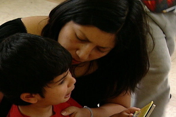 A woman comforts a crying boy.