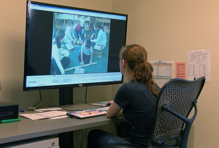 A student researcher using a computer. 