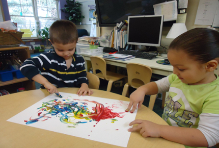 Children playing with finger paints.