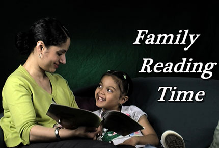 A mother sits on a couch and reads to her daughter. The words "Family Reading Time" appear above them.