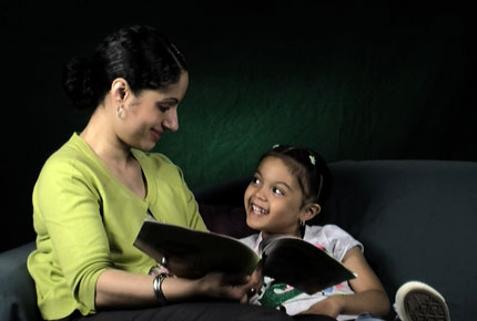 A mother reads to her daughter.