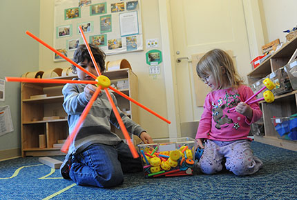 Children playing with tinkertoys.