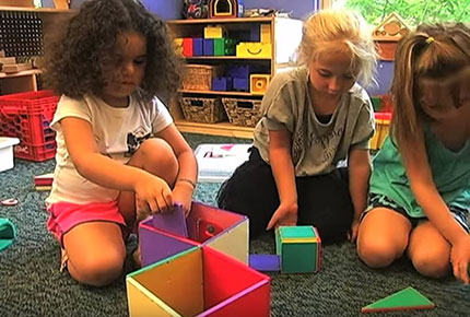 Children building with magnatiles.