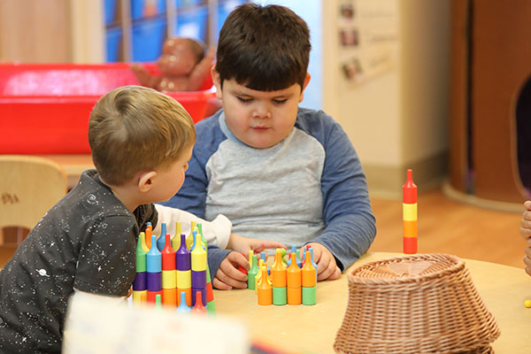 Children playing with bottleclix toy