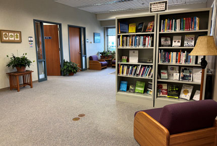 Office area with bookshelves, chair, and reading chair