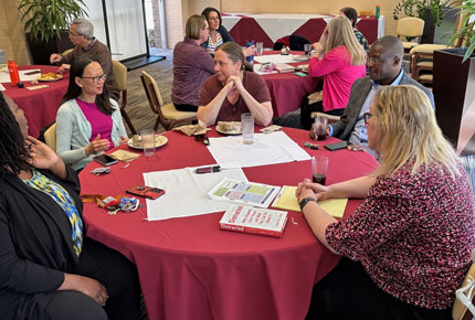Faculty discuss ideas at a round table