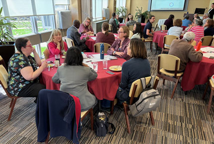 Faculty engage in conversation at round tables