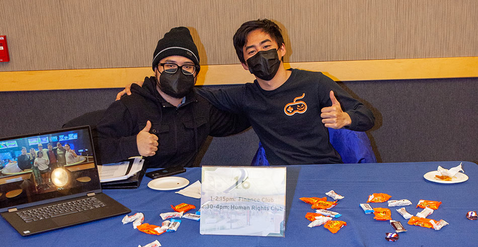 students posing for photo at club fair