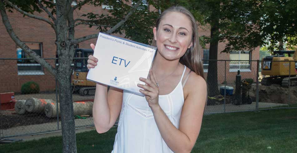 female club member holding ETV sign