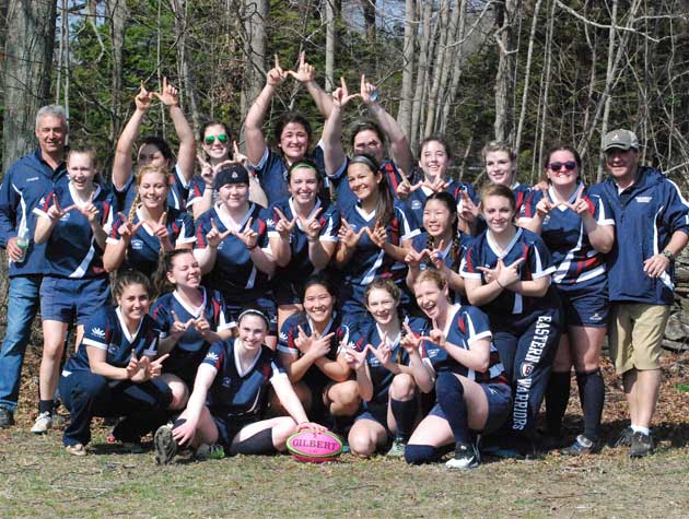 team on field posing for photo