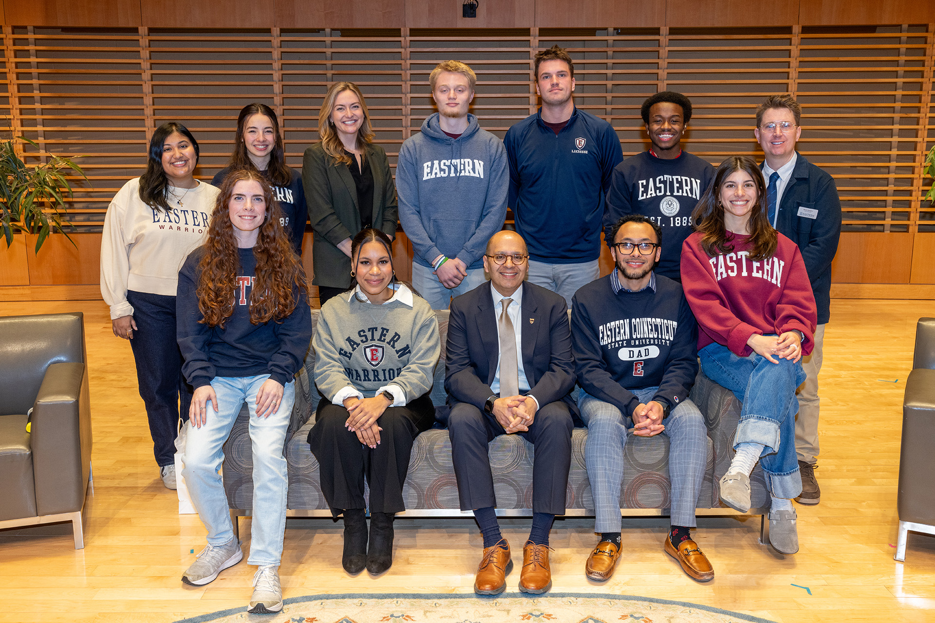 Hailey, Ian, Kylie, Erik, Emily, Brayden, Jaime, Jaiden, Katherine posing for a photo with President Ismaili, Ryan Quigley, and Raena Beetham