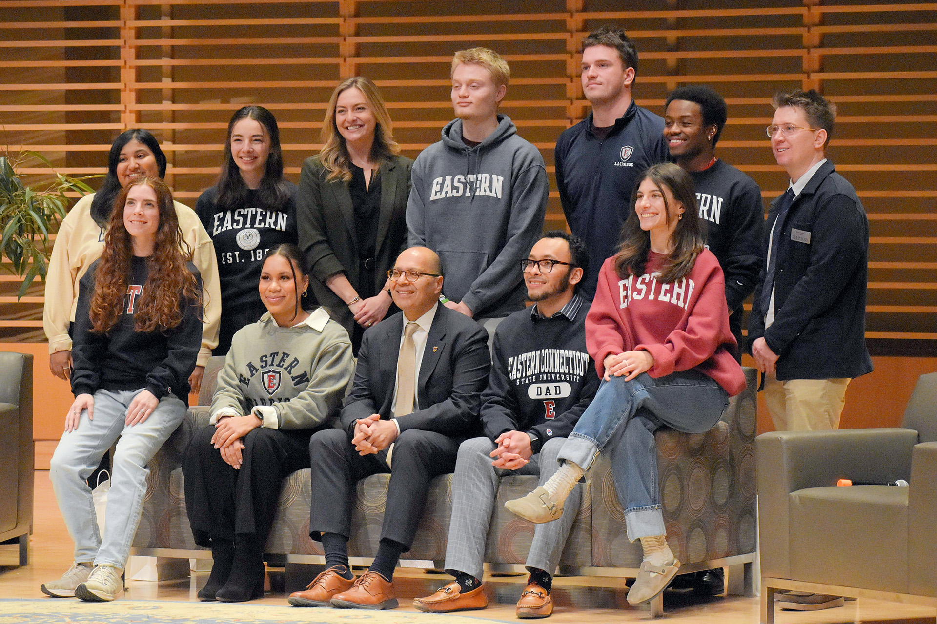 Hailey, Ian, Kylie, Erik, Emily, Brayden, Jaime, Jaiden, Katherine posing for a photo with President Ismaili, Ryan Quigley, and Raena Beetham