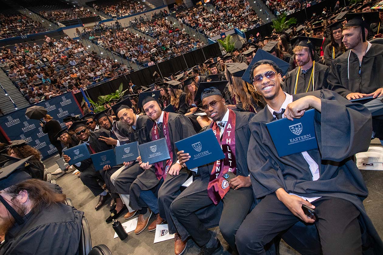graduates show off their diplomas