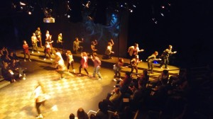 student actors running around on stage
