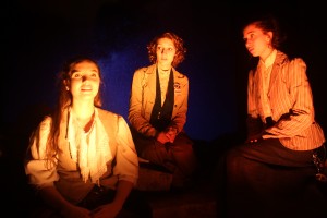 student actors performing while front-lit by light