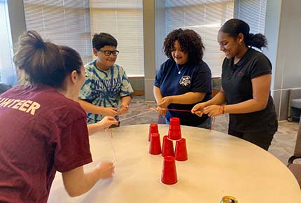 Students playing a game with cups