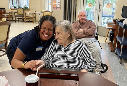 student posing for photo with senior citizen