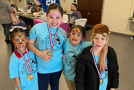 children posing wearing face paint