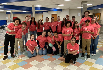 Students posing for photo wearing pink I heart me! t-shirts