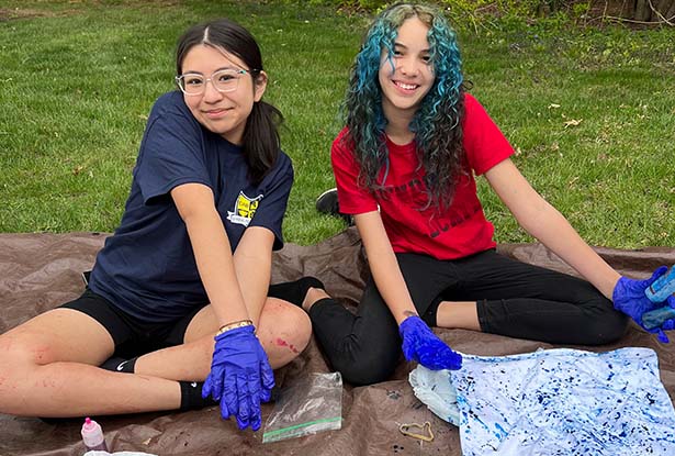 students posing for photo while tie dying