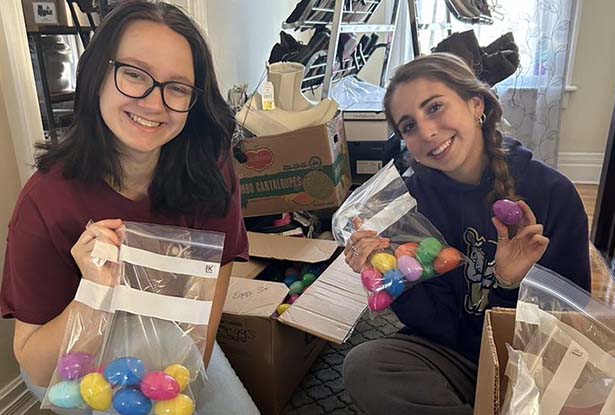 students holding bags of plastic Easter eggs