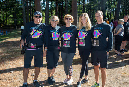 five participants in the Andrej 5K race posing for photo