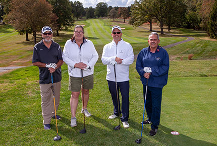 golfers posing for photo