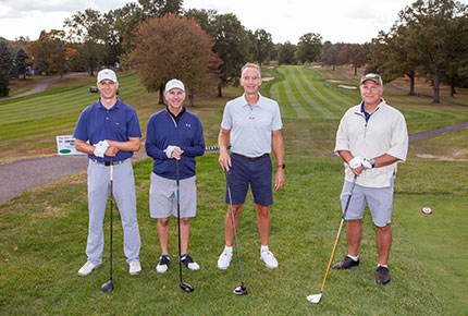 golfers posing for photo