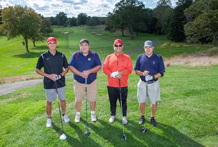 golfers posing for photo