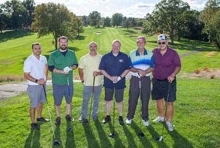 golfers posing for photo