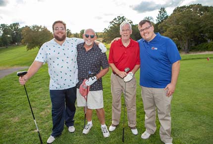 golfers posing for photo