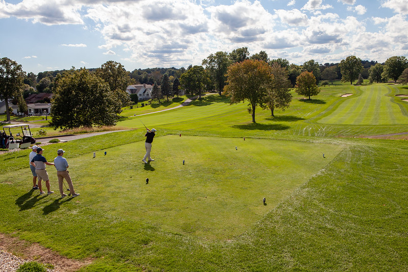 Golfers playing golf during an event by Eastern's Development office